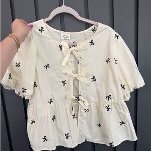 Elegant Cream Blouse with Black Bow Accents